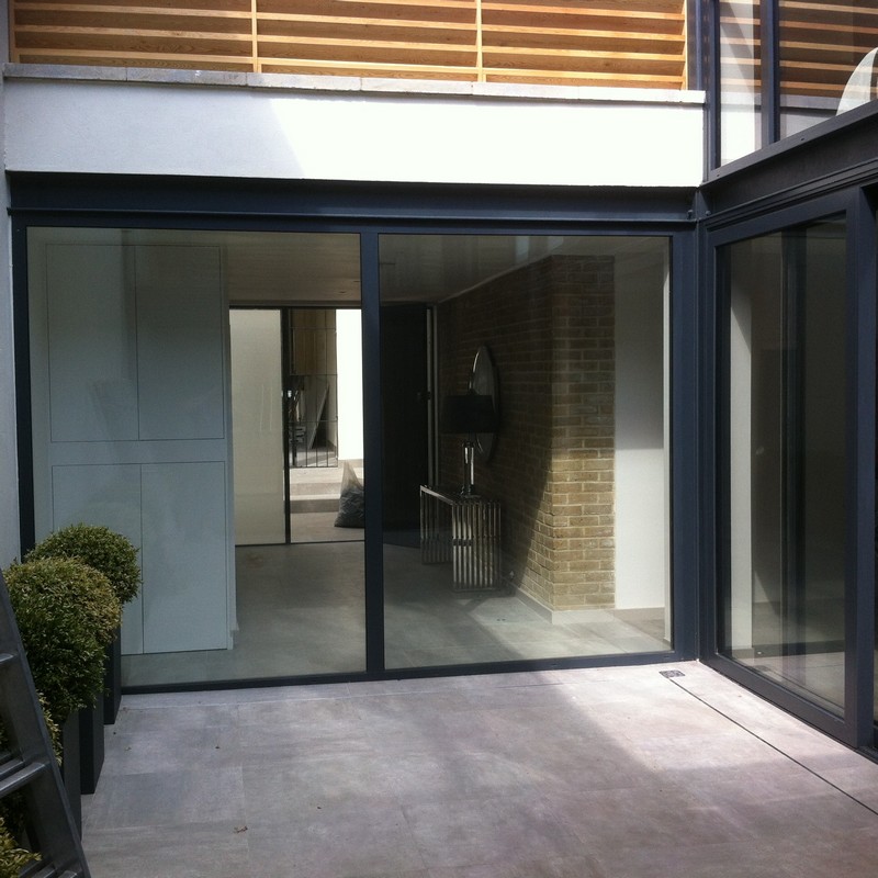 Floor-to-ceiling sliding doors opening to courtyard in Earl's Court