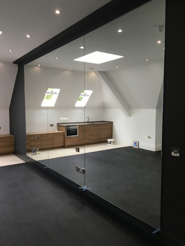 Frameless glass partition in loft conversion by Earl's Court glaziers